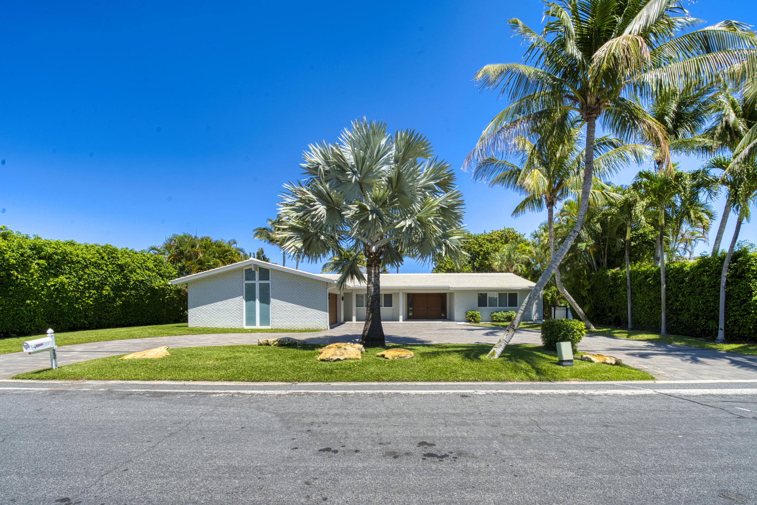 2259 Ibis Isle Road East Palm Beach, FL 33480 - Photo 2 of 35 a front view of a house with garden
