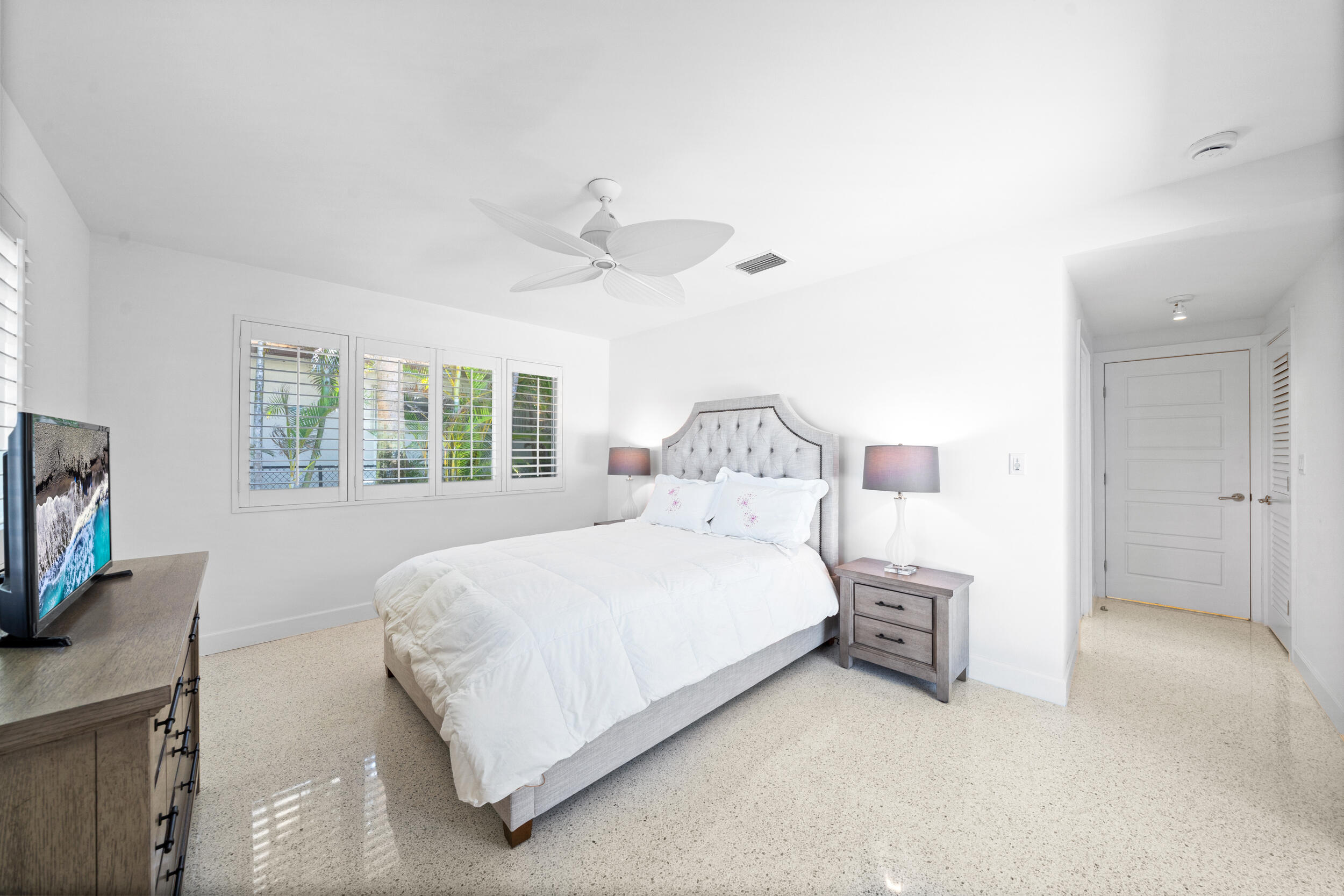 2259 Ibis Isle Road East Palm Beach, FL 33480 - Photo 22 of 35 a bedroom with a bed and a flat screen tv