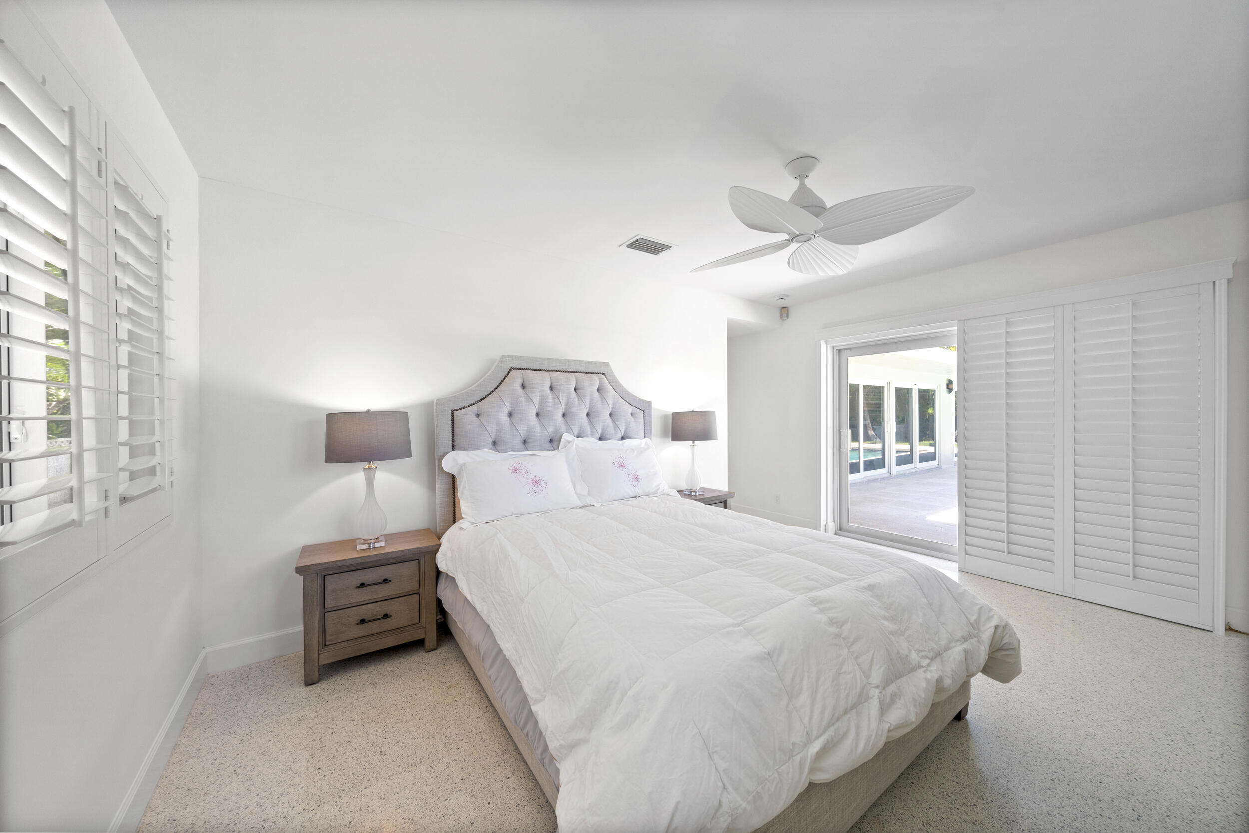 2259 Ibis Isle Road East Palm Beach, FL 33480 - Photo 23 of 35 a bedroom with a bed and a large window