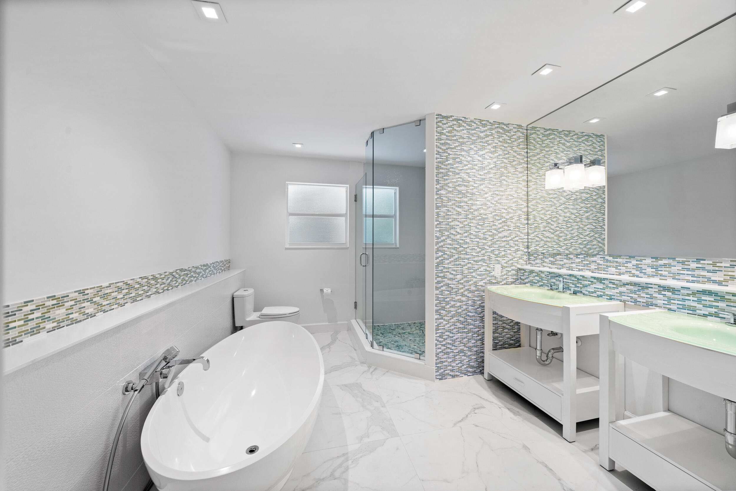 2259 Ibis Isle Road East Palm Beach, FL 33480 - Photo 24 of 35 a bathroom with a sink a toilet and shower
