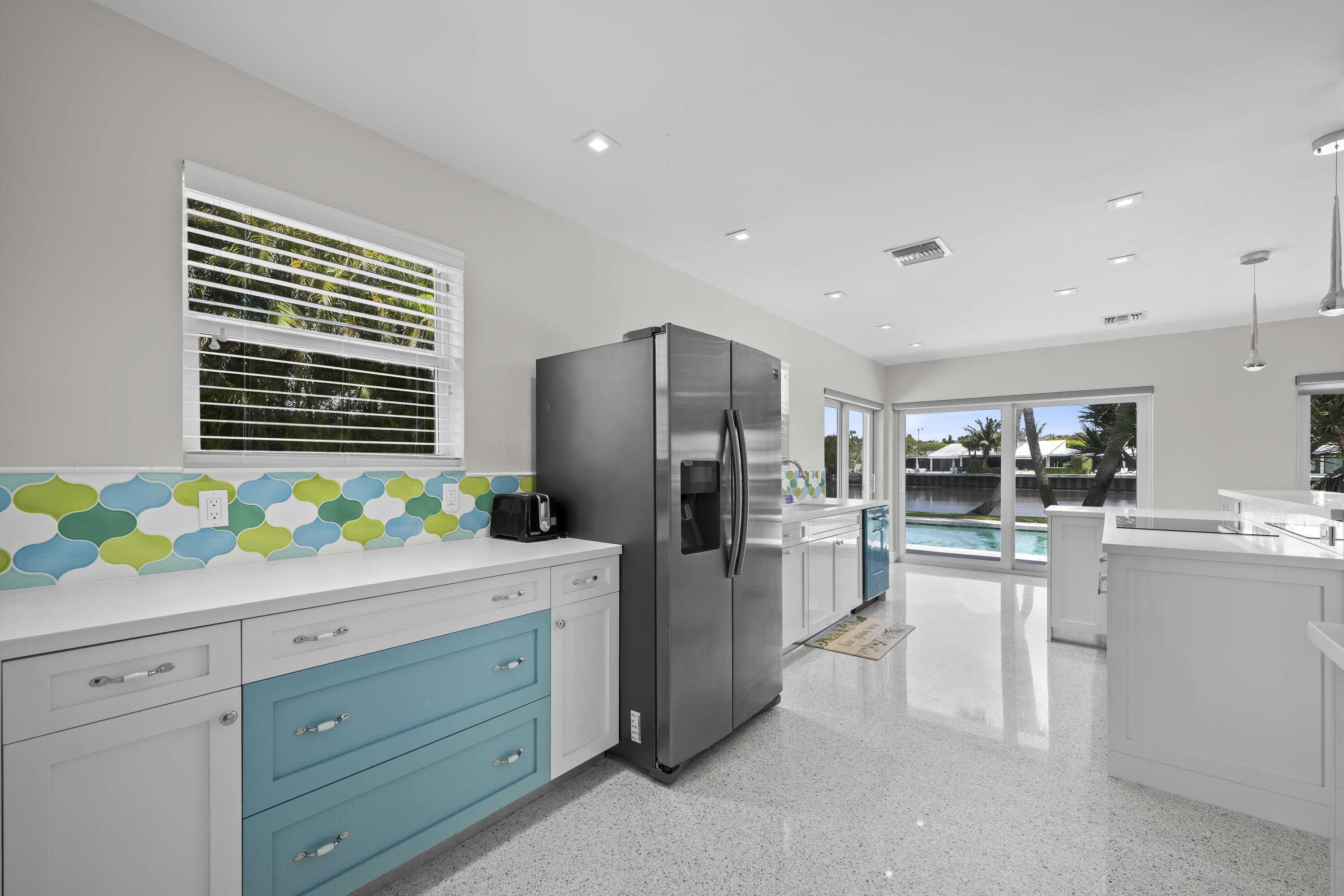 2259 Ibis Isle Road East Palm Beach, FL 33480 - Photo 9 of 35 a kitchen with a refrigerator and a sink