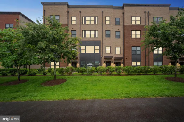 a front view of building with yard and green space