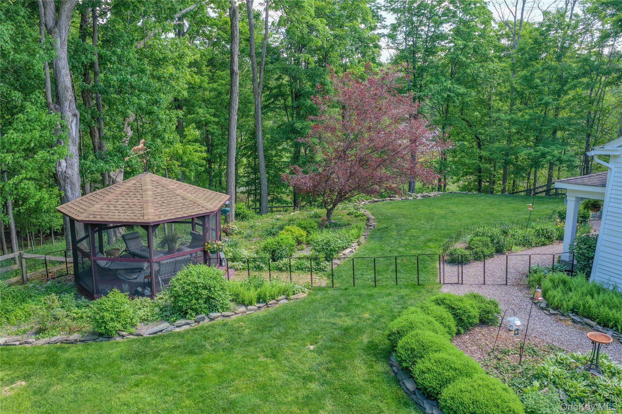 121 Coutant Road Circleville, NY 10919 - Photo 6 of 7 a view of a backyard with table and chairs potted plants and large tree