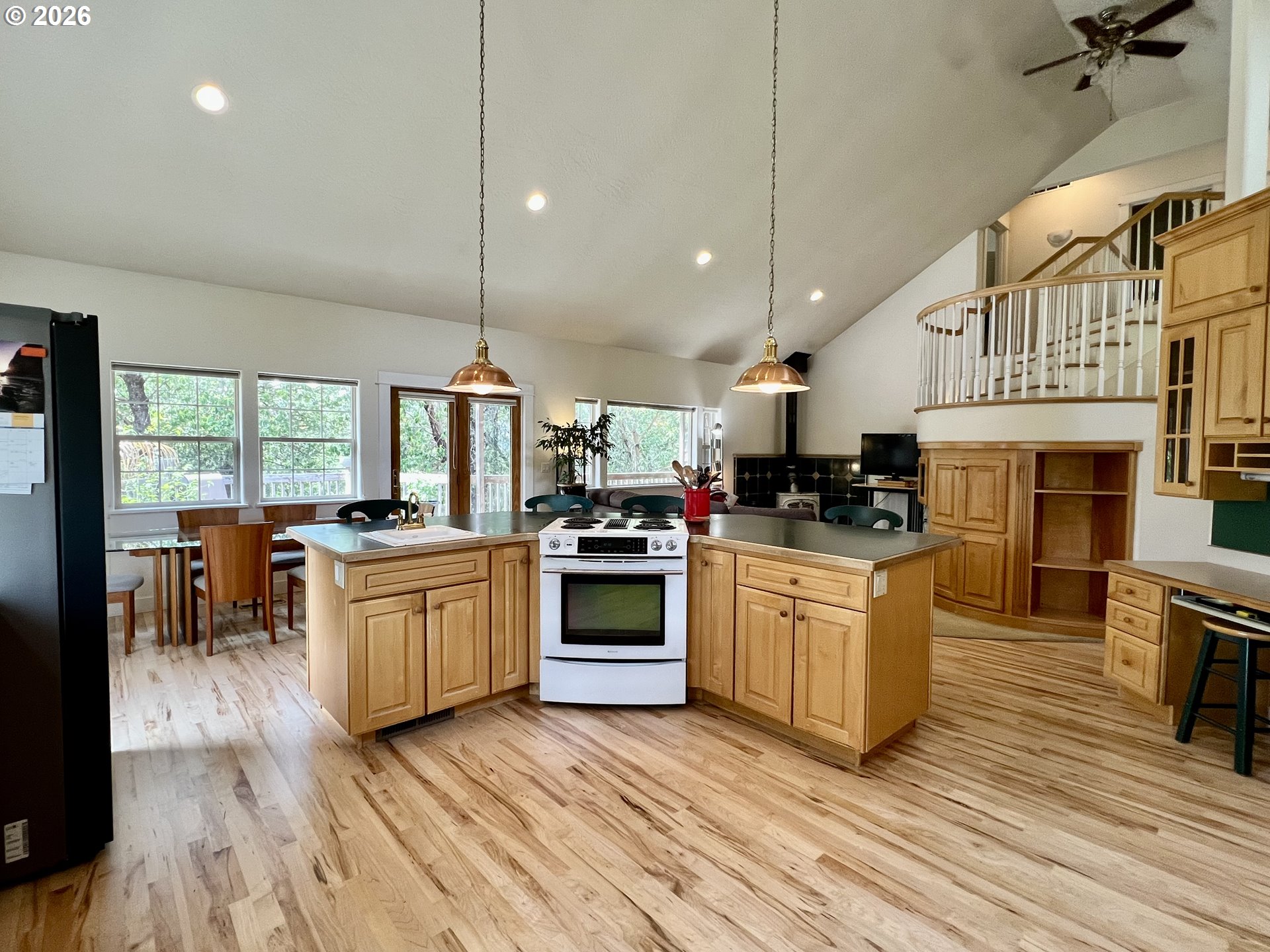 28544 Crow Road Eugene, OR 97402 - Photo 10 of 48 a kitchen with granite countertop a stove top oven a sink a dining table and chairs