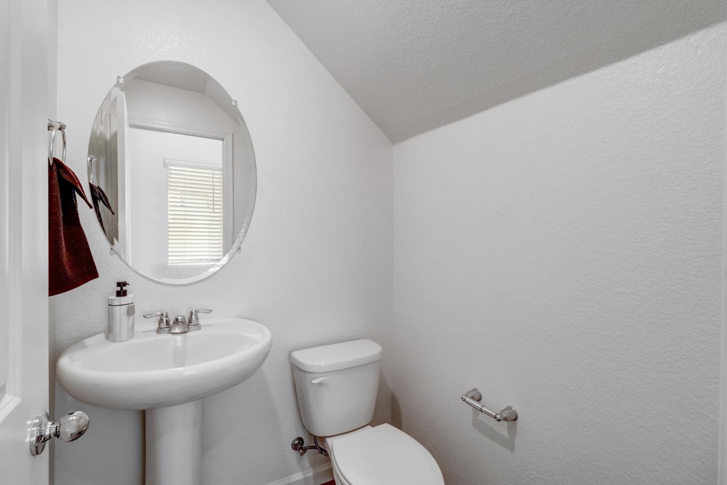 2887 Krone Way Antelope, CA 95843 - Photo 35 of 46 a bathroom with a toilet sink and mirror