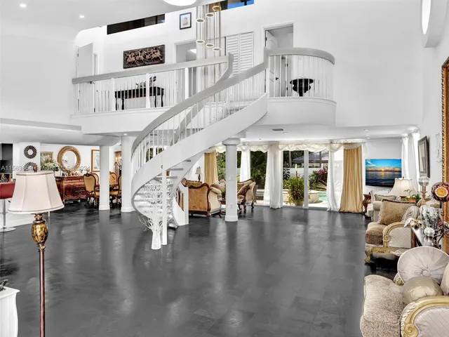 a living room with furniture and a dining table with wooden floor