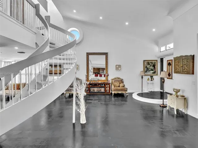 a view of a dining room with furniture a chandelier and wooden floor