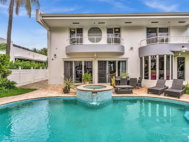 a front view of a house with a garden and swimming pool