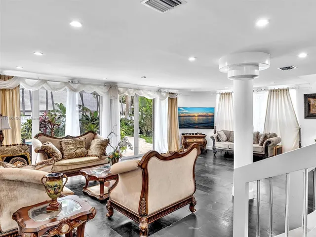 a kitchen with stainless steel appliances granite countertop a sink a stove and cabinets