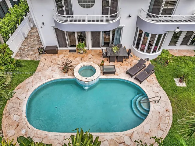 an aerial view of a house with yard patio and deck