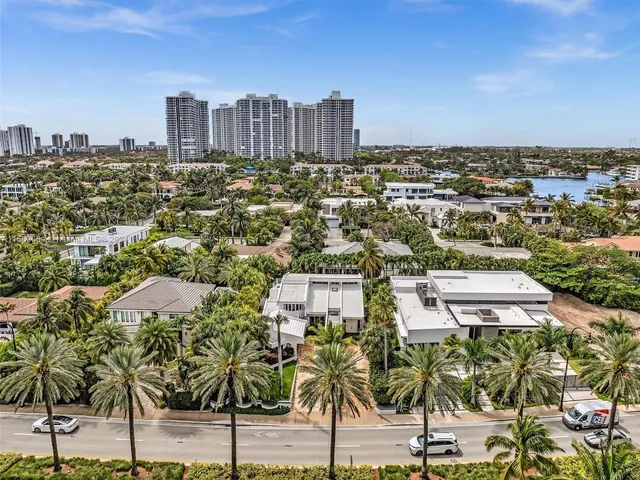 a view of a house with a yard and potted plants