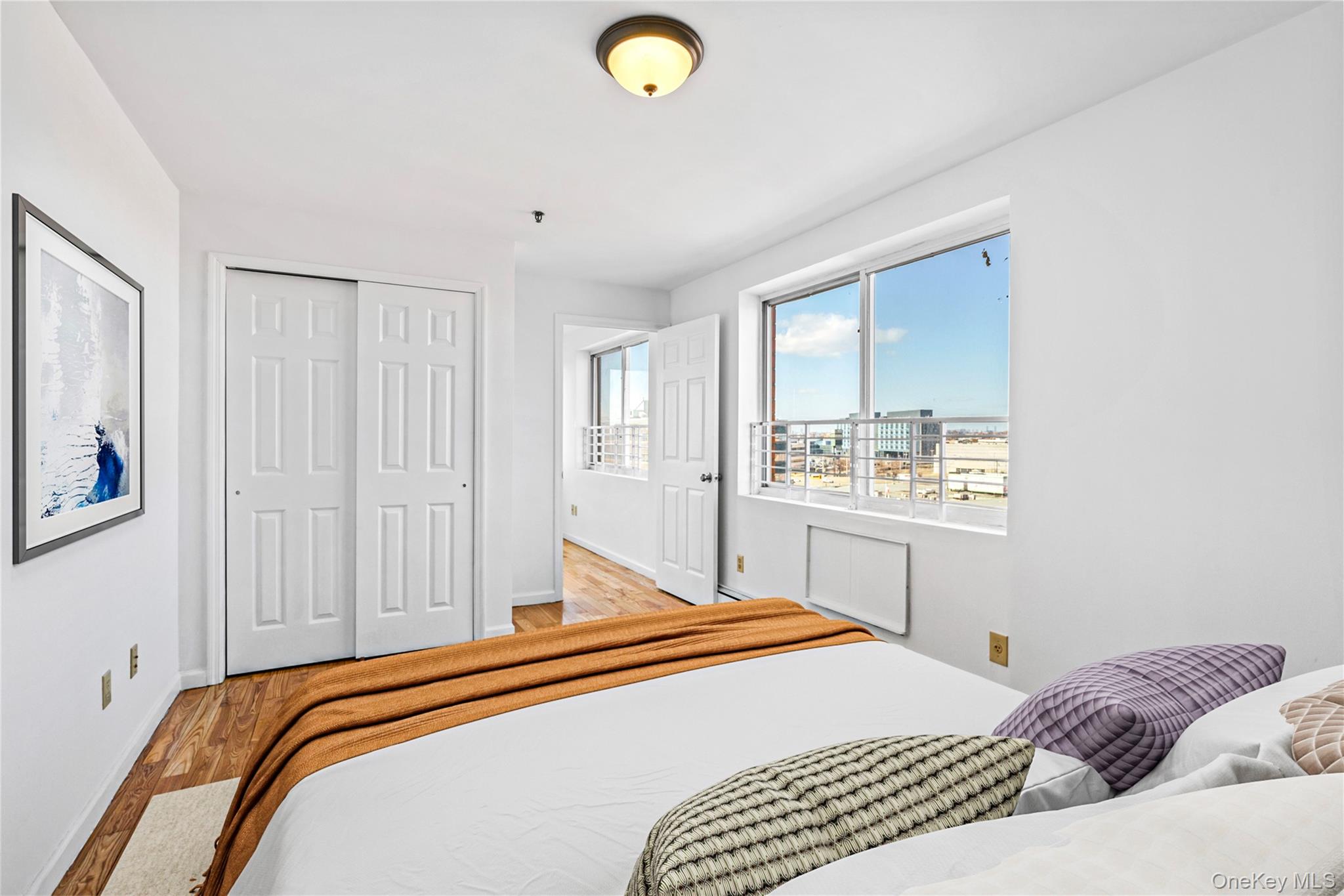 136-16 31st Road, Unit 8B Queens, NY 11354 - Photo 10 of 23 Virtual Staged Bedroom featuring wood finished floors, baseboards, and a closet
