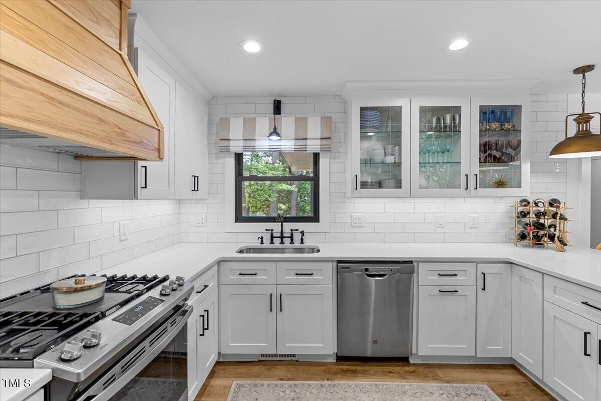 5700 Tully Court Raleigh, NC 27609 - Photo 11 of 26 a kitchen with a stove and a sink