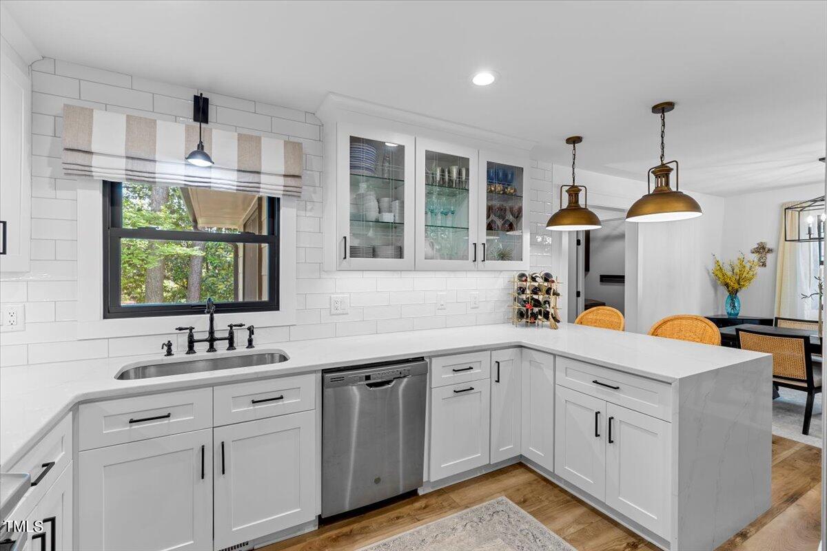 5700 Tully Court Raleigh, NC 27609 - Photo 13 of 26 a kitchen with white cabinets and sink