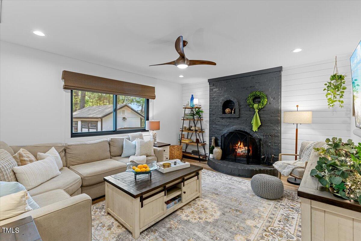 5700 Tully Court Raleigh, NC 27609 - Photo 14 of 26 a living room with furniture and a fireplace