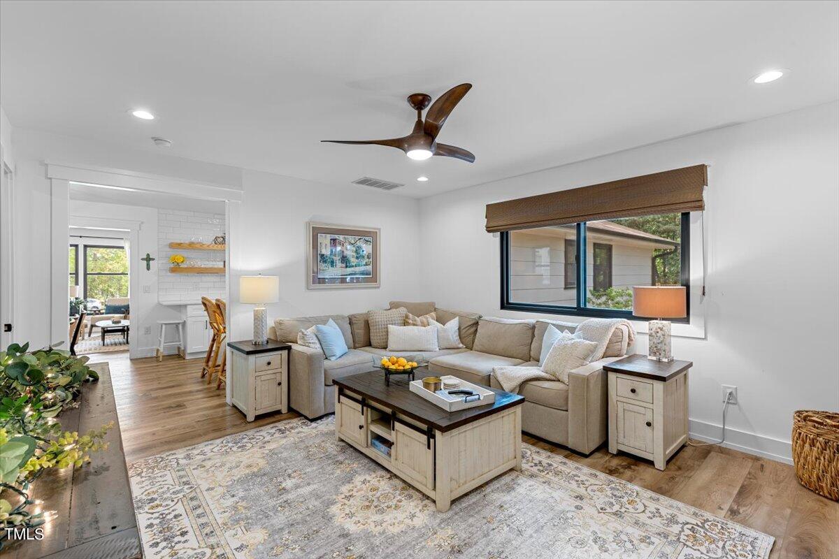 5700 Tully Court Raleigh, NC 27609 - Photo 15 of 26 a living room with furniture and a large window