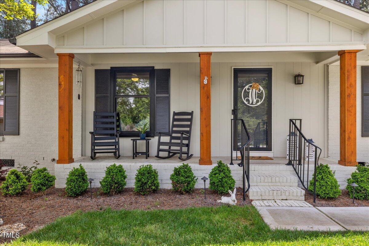 5700 Tully Court Raleigh, NC 27609 - Photo 2 of 26 a front view of a house with garden