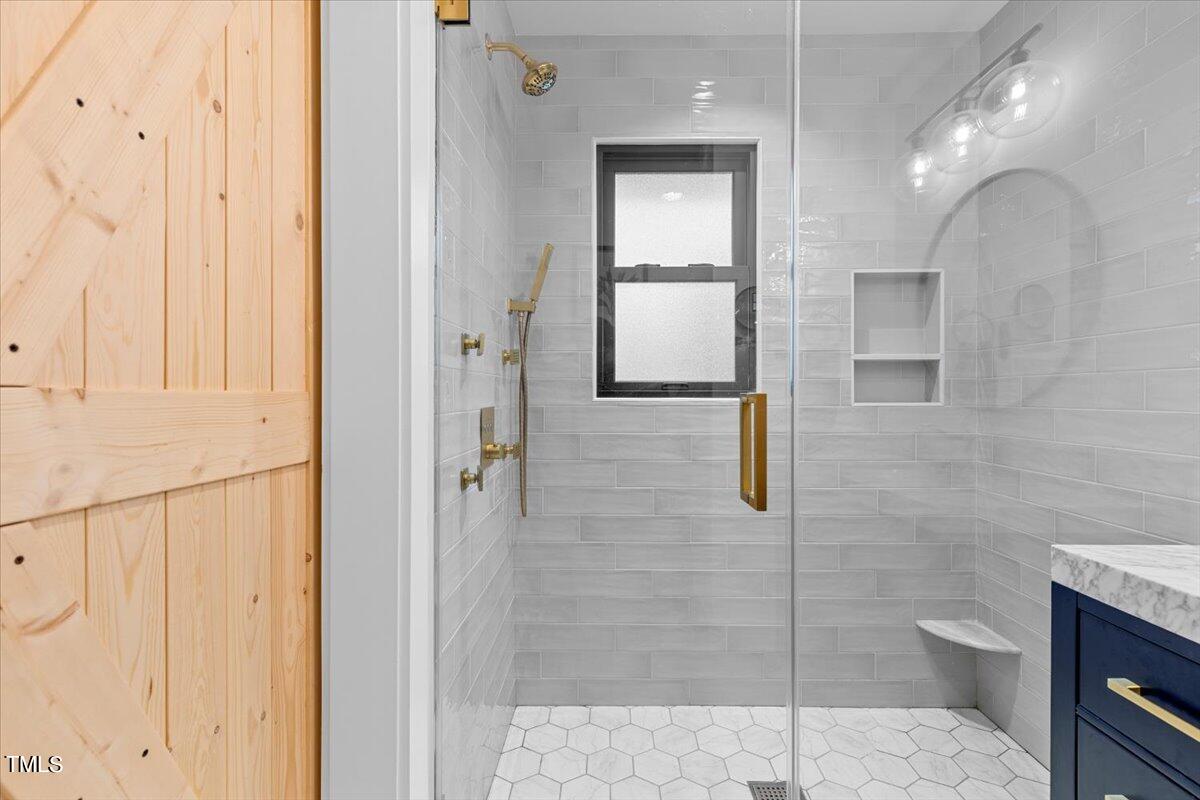5700 Tully Court Raleigh, NC 27609 - Photo 22 of 26 a bathroom with a shower