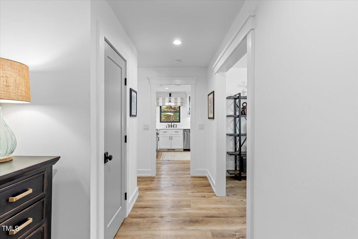 5700 Tully Court Raleigh, NC 27609 - Photo 3 of 26 a view of a hallway with wooden floor and staircase