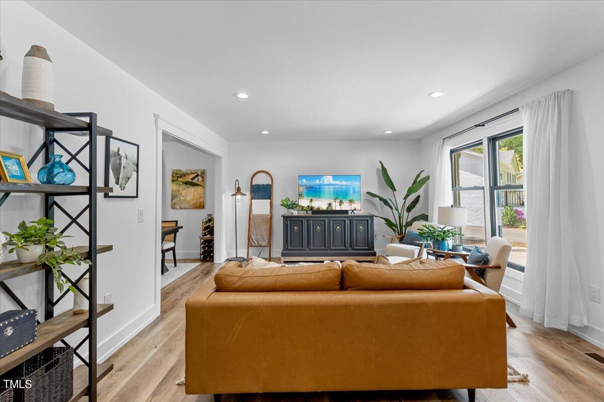 5700 Tully Court Raleigh, NC 27609 - Photo 4 of 26 a living room with furniture and a potted plant