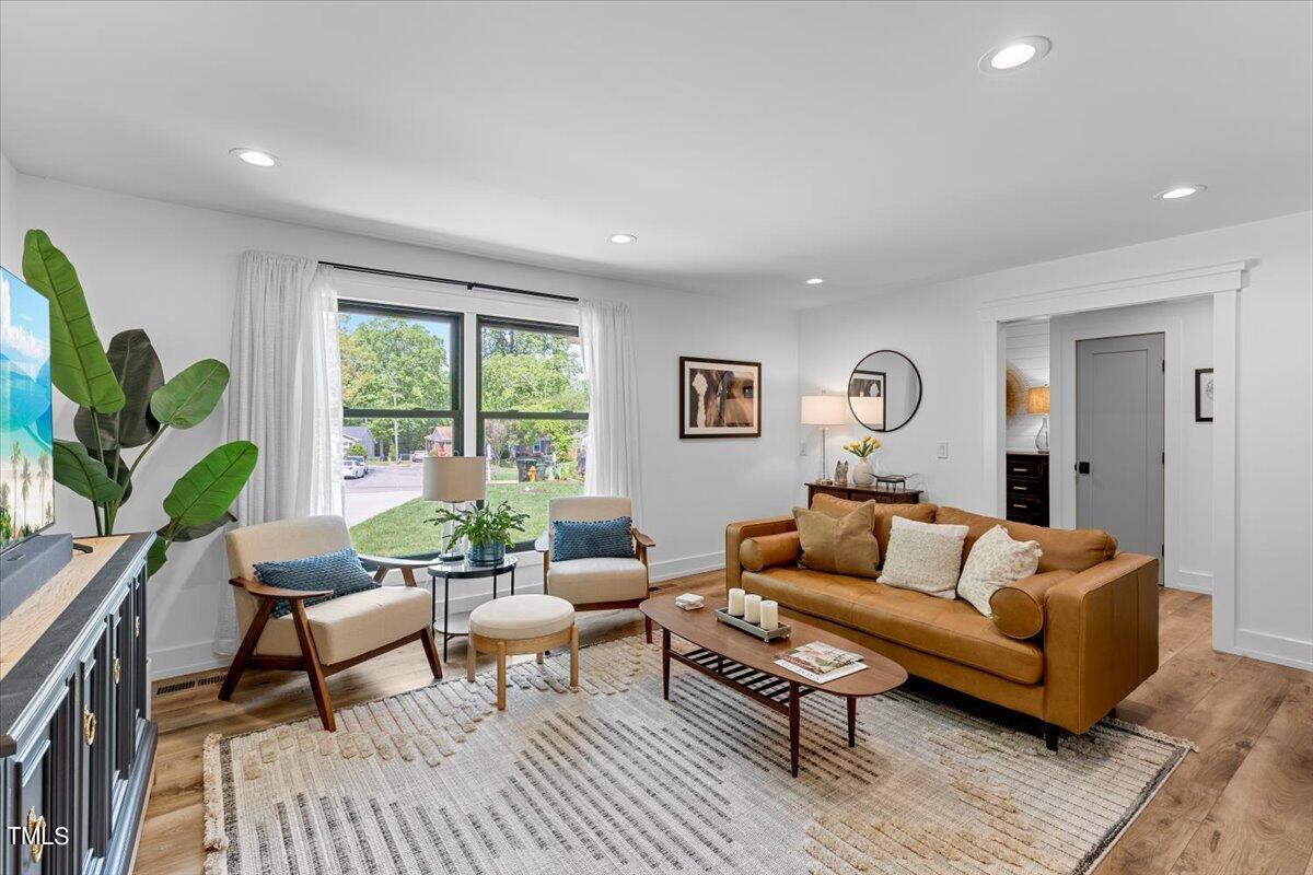 5700 Tully Court Raleigh, NC 27609 - Photo 6 of 26 a living room with furniture and a large window