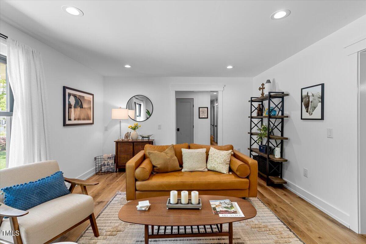 5700 Tully Court Raleigh, NC 27609 - Photo 7 of 26 a living room with furniture a rug and a window
