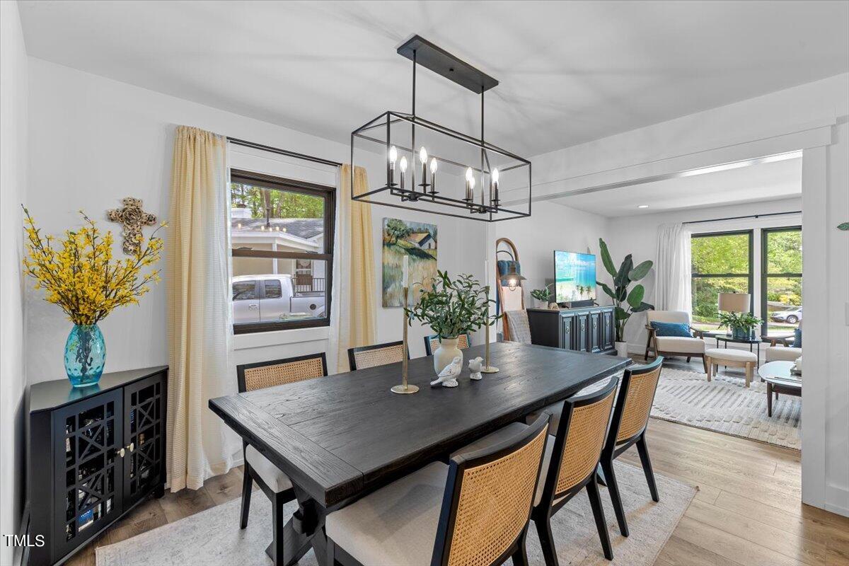5700 Tully Court Raleigh, NC 27609 - Photo 9 of 26 a view of a dining room with furniture window and wooden floor