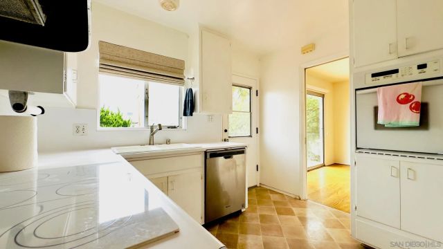 a view of a kitchen with a sink and cabinets