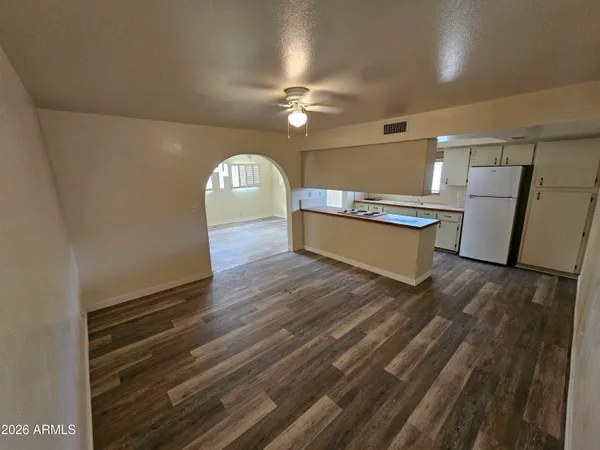 a view of a room with wooden floor