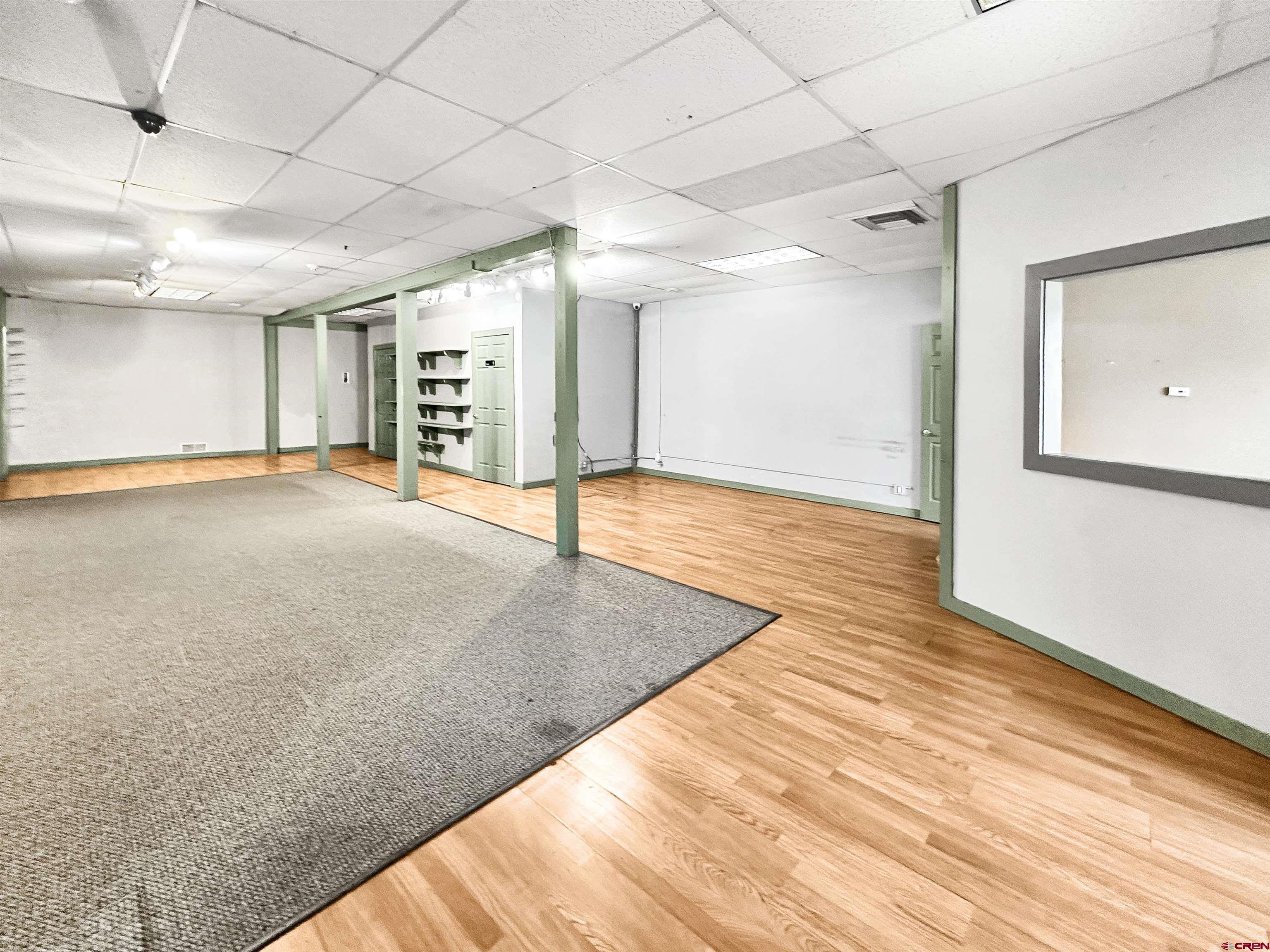 310 East Main Street Cortez, CO 81321 - Photo 3 of 21 a view of an empty room with wooden floor