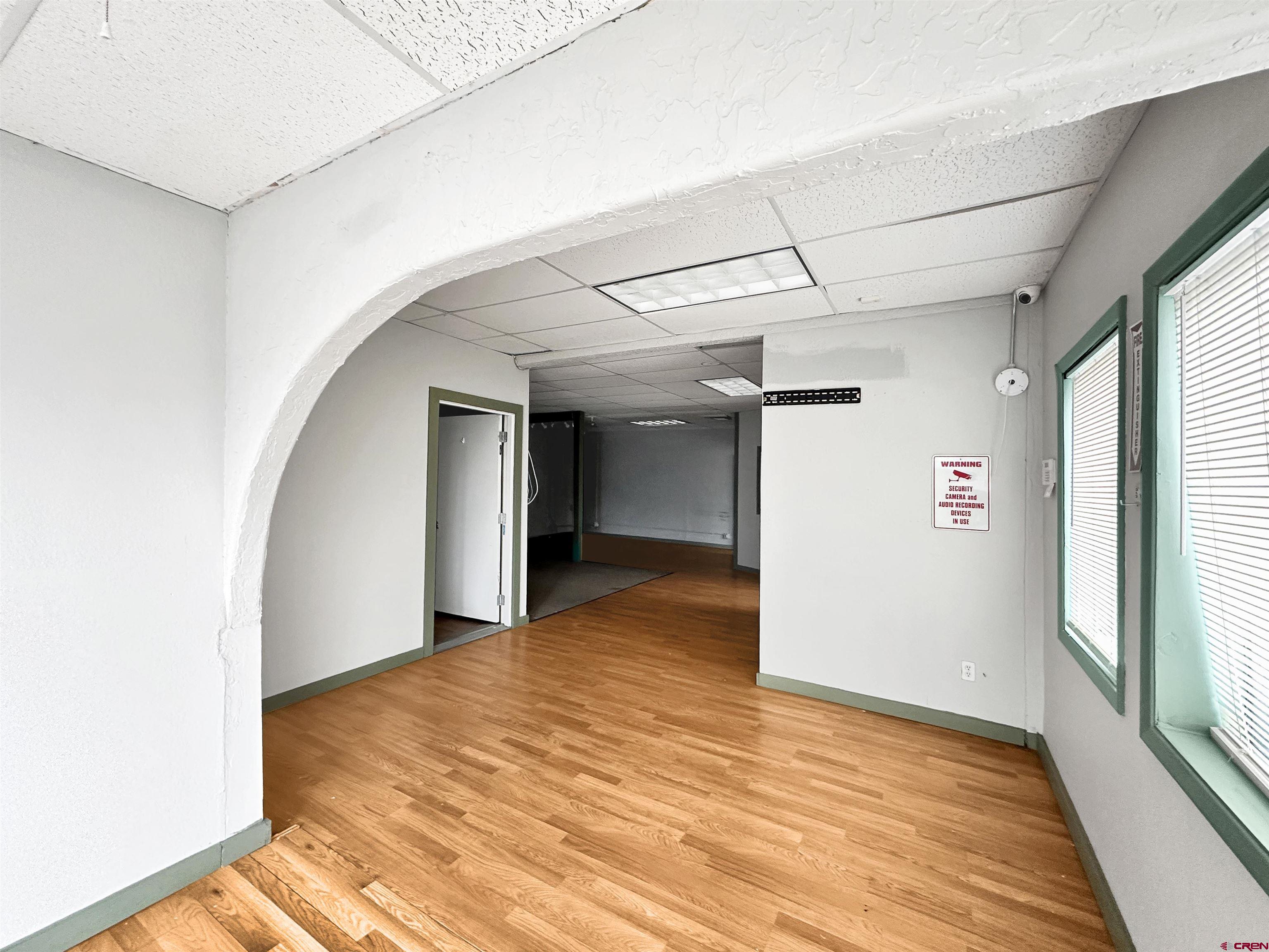 310 East Main Street Cortez, CO 81321 - Photo 5 of 21 a view of empty room with wooden floor and fan