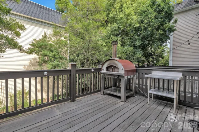 a view of a wooden deck and a backyard