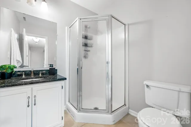 a bathroom with a granite countertop sink a mirror and a shower