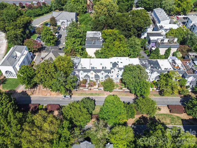 an aerial view of multiple houses with yard