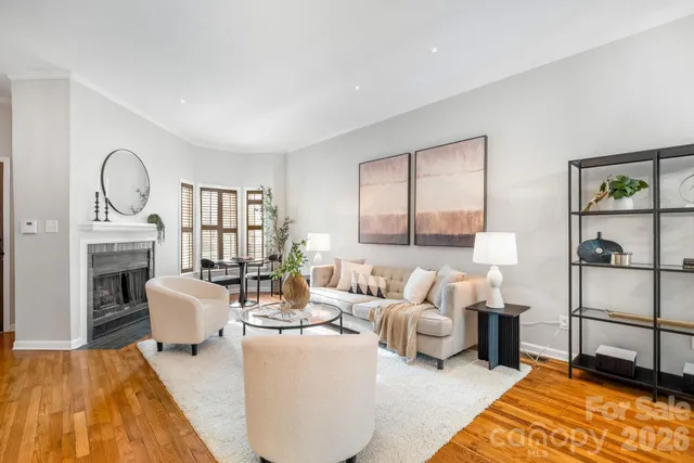 a living room with furniture a fireplace and decor
