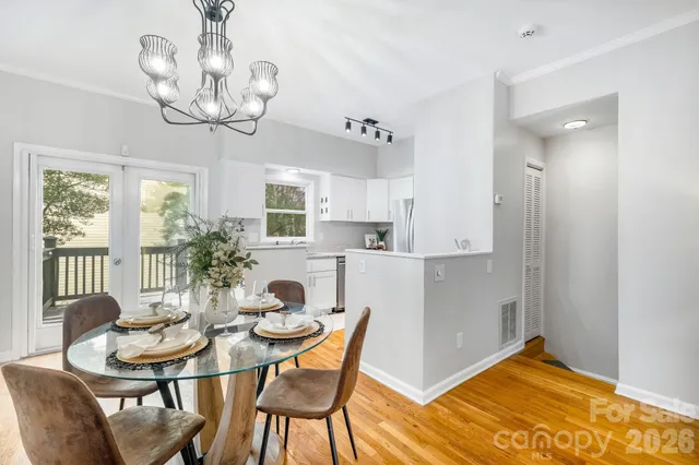 a view of a dining room with furniture wooden floor and chandelier