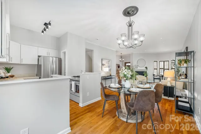 a view of a dining room with furniture wooden floor and chandelier