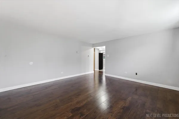 a view of an empty room and wooden floor