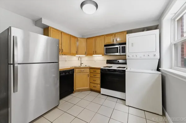 a kitchen with a refrigerator sink and microwave