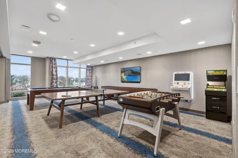 a living room with furniture a table and a flat screen tv