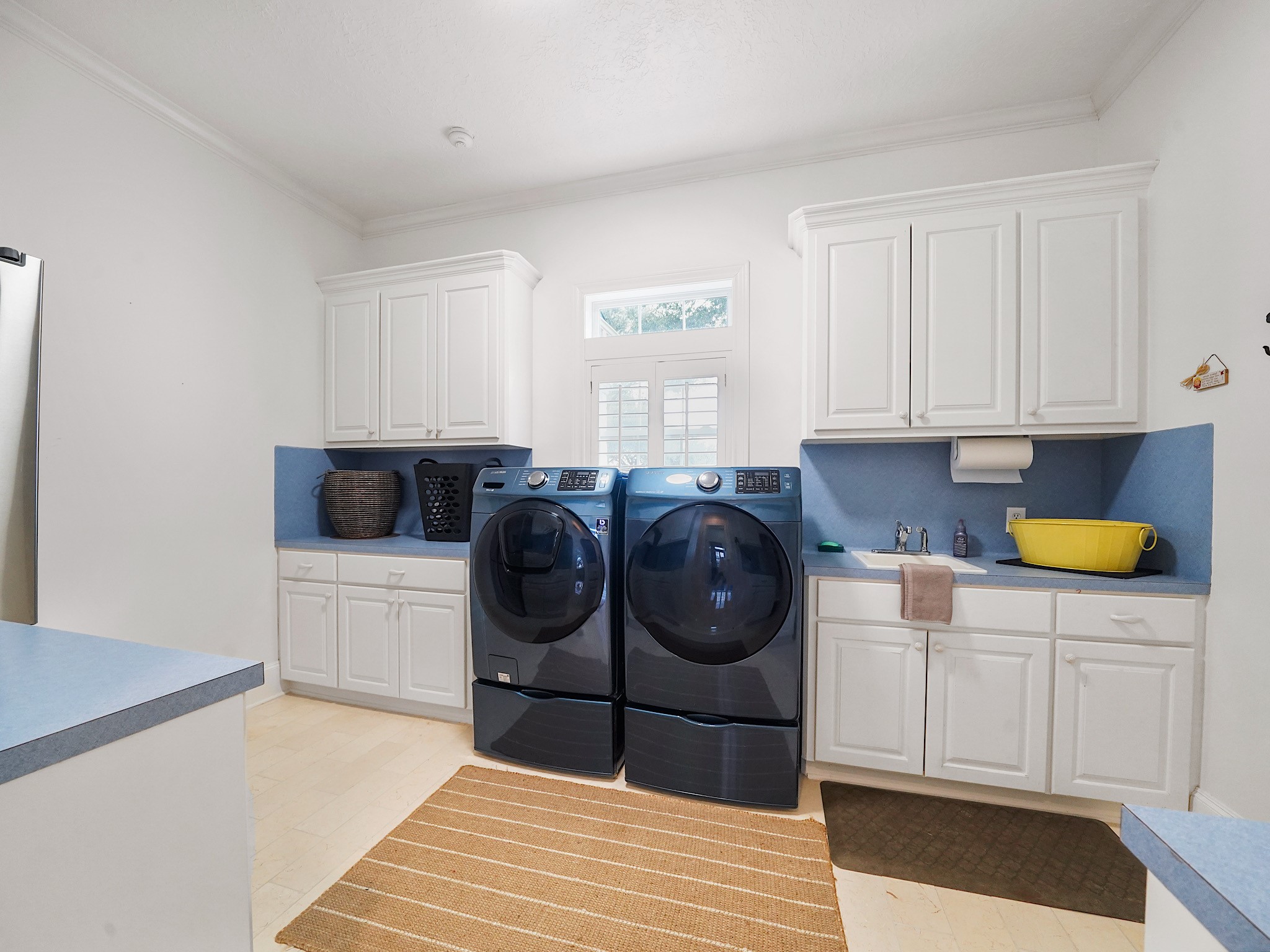 32134 Fulbrook Commons Fulshear, TX 77441 - Photo 27 of 49 The oversized utility room offers abundant cabinetry and workspace, thoughtfully designed to combine efficiency with organization.