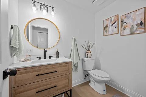 an aerial view of a house with garden space and trees all around