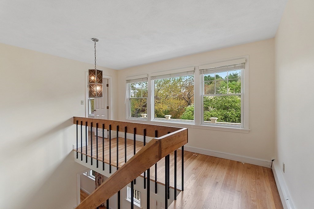 147 Silver Hill Road Concord, MA 01742 - Photo 12 of 28 a view of hallway with window and wooden floor