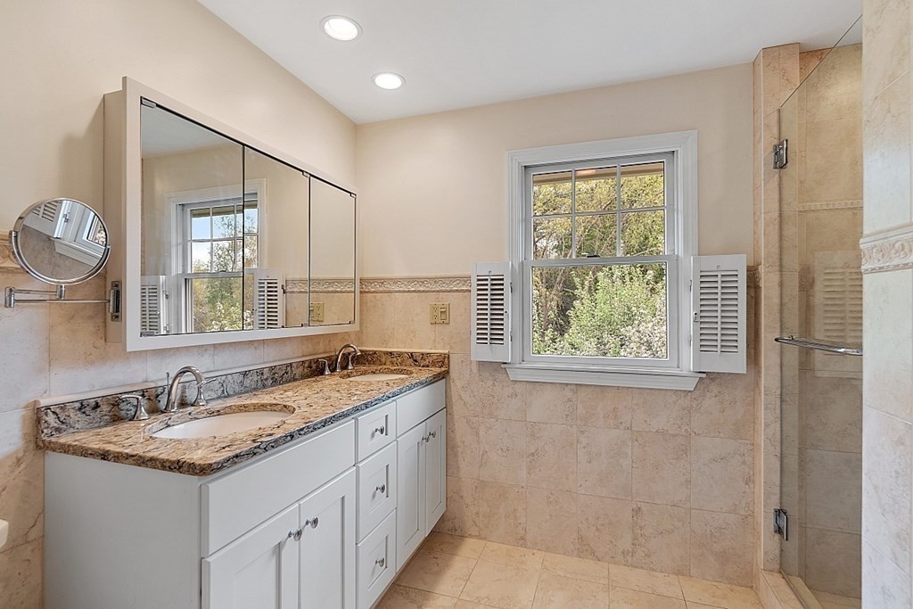 147 Silver Hill Road Concord, MA 01742 - Photo 15 of 28 a bathroom with a granite countertop sink a mirror and a shower