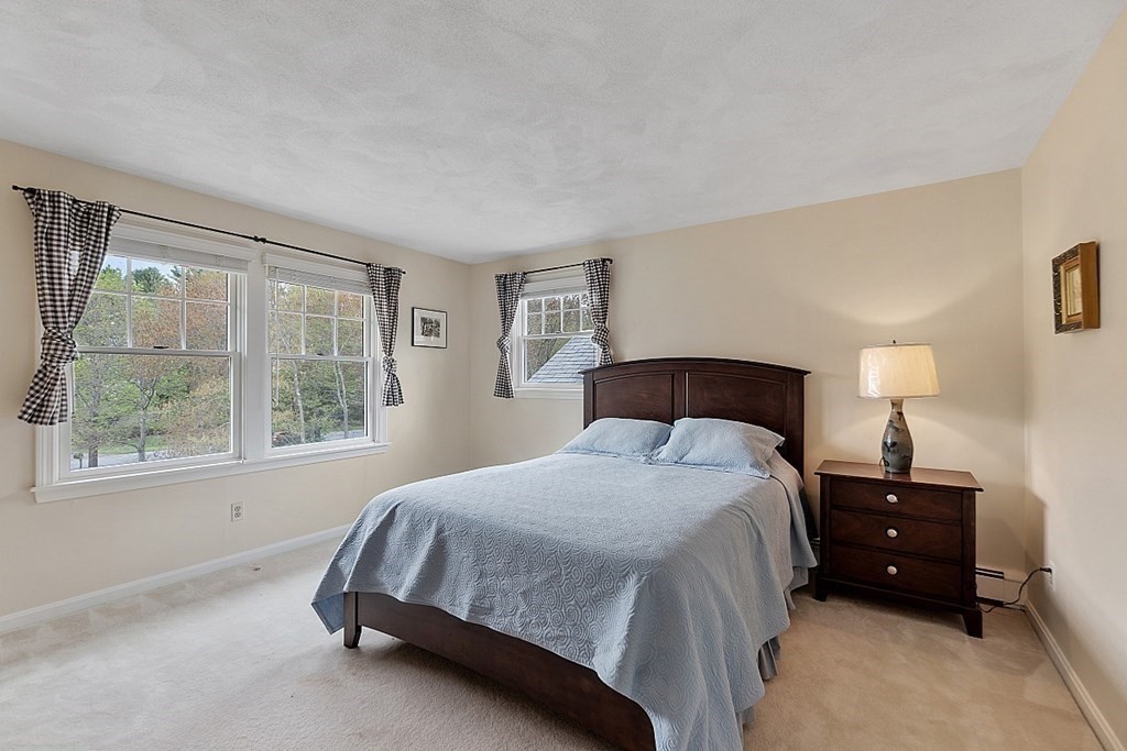 147 Silver Hill Road Concord, MA 01742 - Photo 17 of 28 a spacious bedroom with a bed and a window