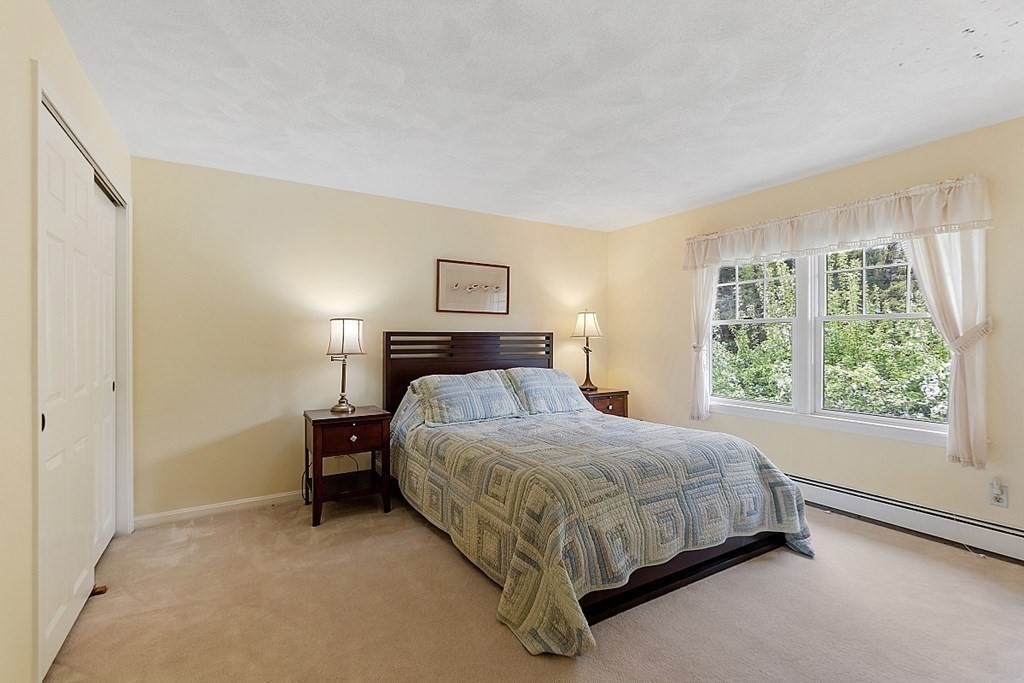 147 Silver Hill Road Concord, MA 01742 - Photo 19 of 28 a bedroom with a bed lamp and window