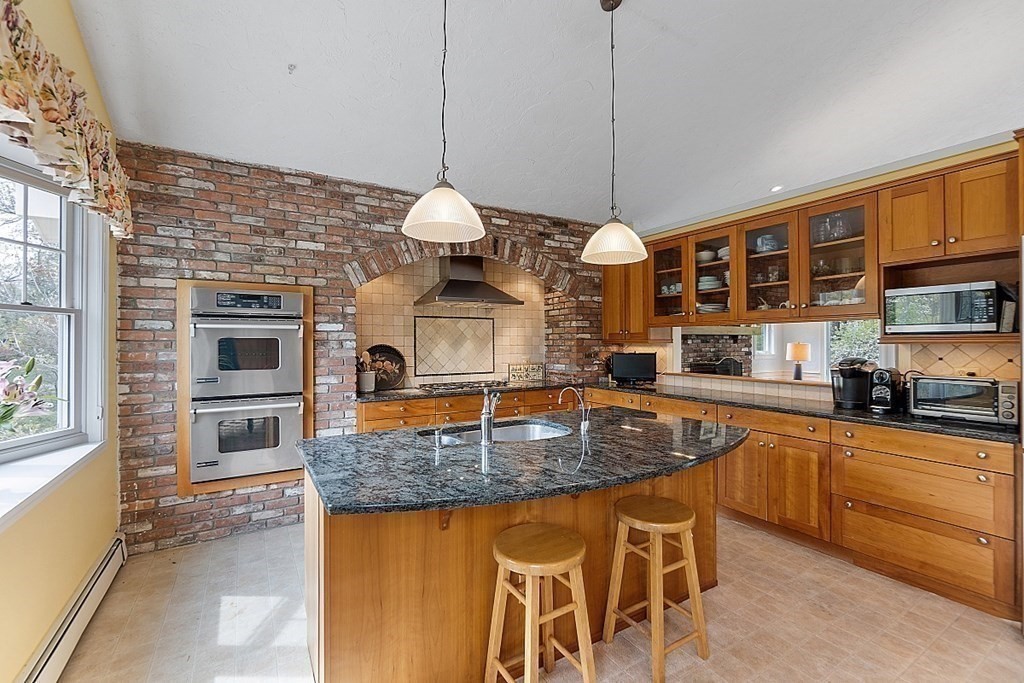 147 Silver Hill Road Concord, MA 01742 - Photo 7 of 28 a kitchen with stainless steel appliances granite countertop a stove a sink and a microwave