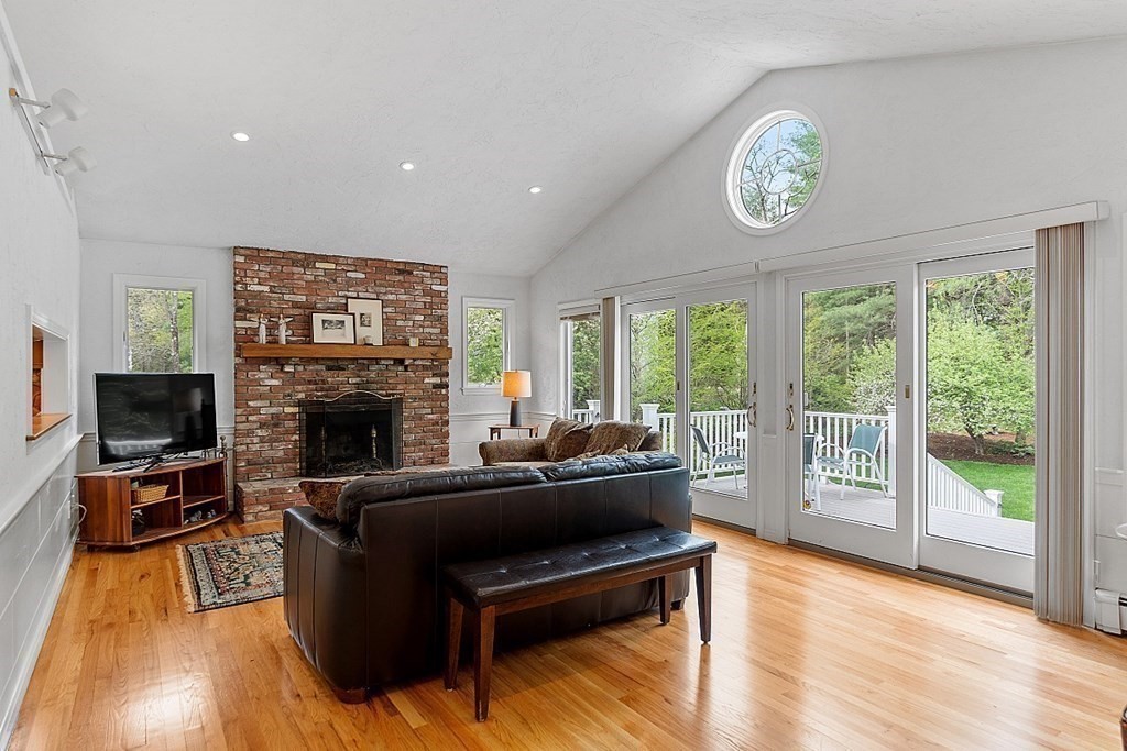 147 Silver Hill Road Concord, MA 01742 - Photo 8 of 28 a living room with furniture a large window and a fireplace