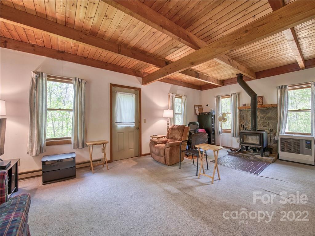 86 Confederate Road Clyde, NC 28721 - Photo 4 of 26 a living room with furniture gym equipment and large windows