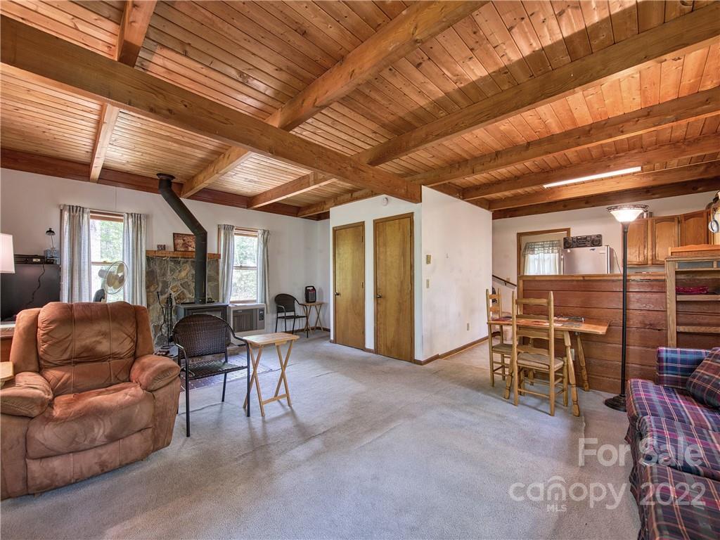 86 Confederate Road Clyde, NC 28721 - Photo 6 of 26 a living room with furniture a ceiling fan and a window
